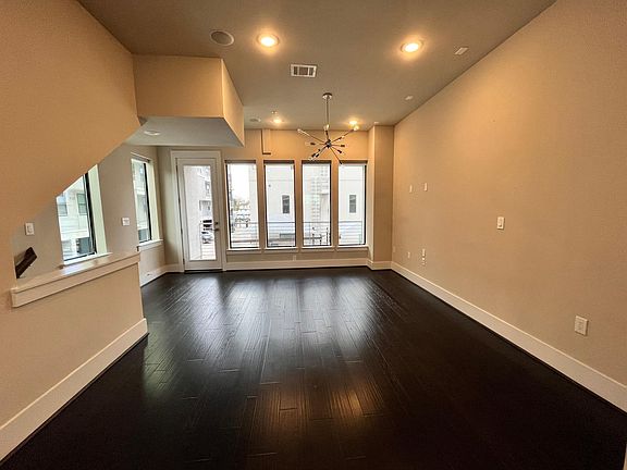 Living space from kitchen looking out to private balcony. Gas valve on balcony for natural gas grills.