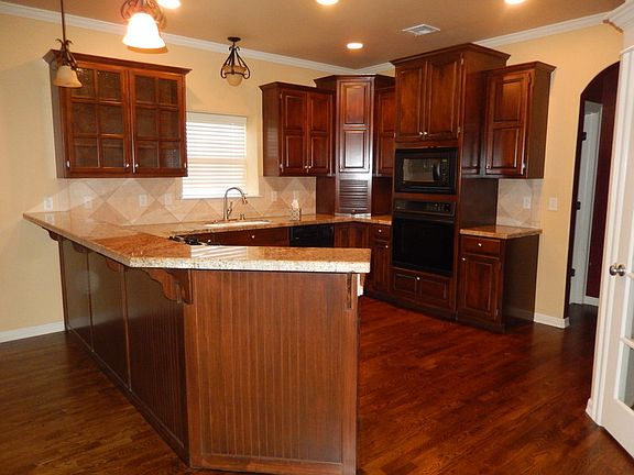 Functional kitchen
						:
						Granite countertops with raised bar. Fridge space w/wood wine rack built-in.