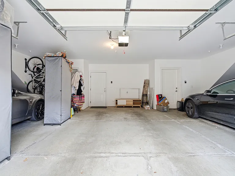 Attached 1-car garage (cars belong to the other units)