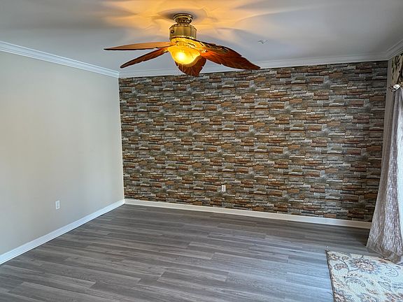 Main studio, view from private bathroom. To right, see curtains to sliding glass doors and deck with pond view.