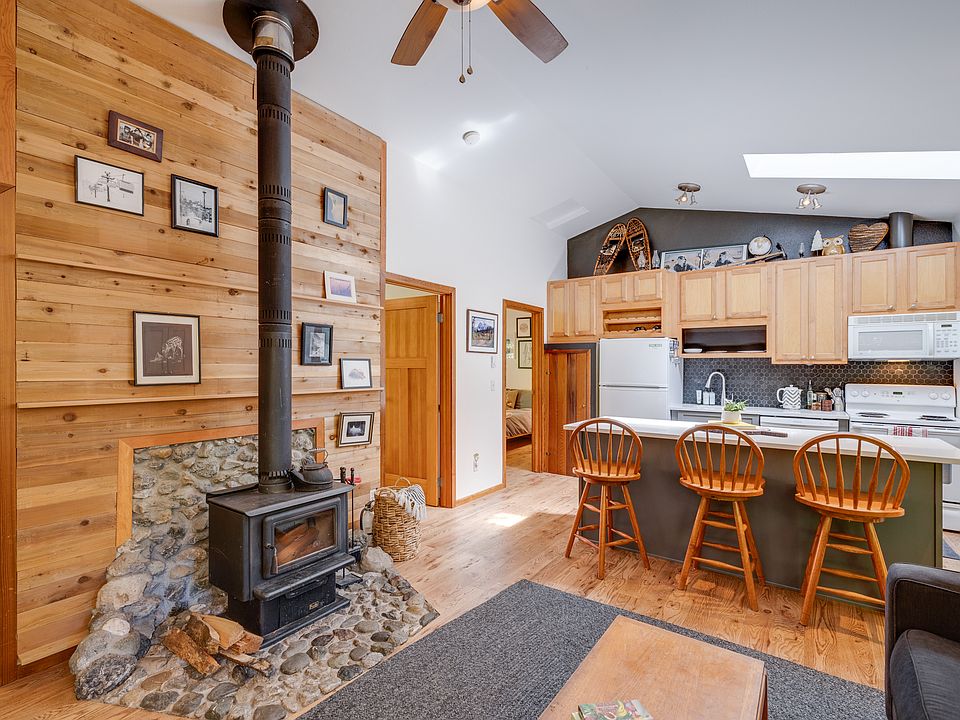 wood stove, living room and kitchen, with bedrooms off to the left.