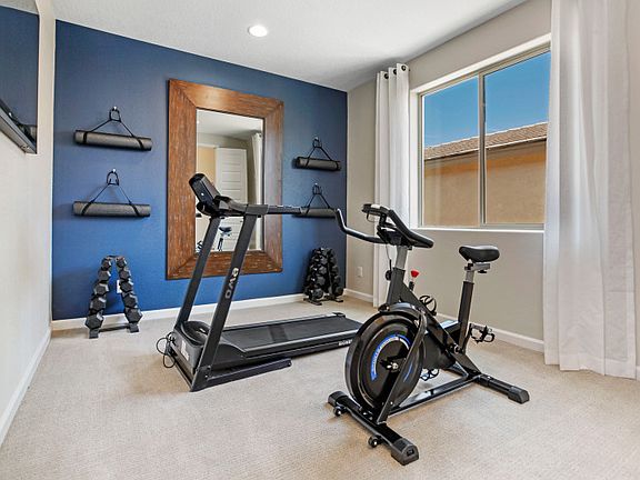 To the left of the foyer you will find bedroom 2, which is shown as a functional home gym.