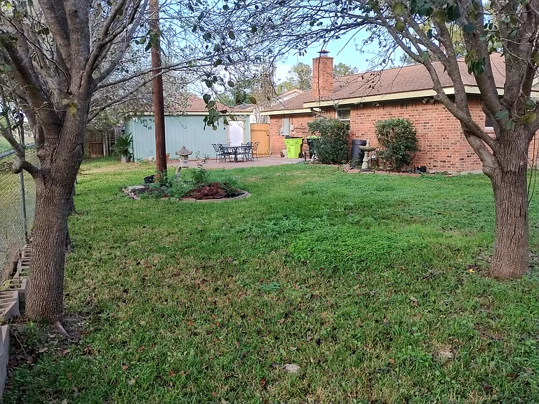 From back corner of backyard facing patio of backyard.