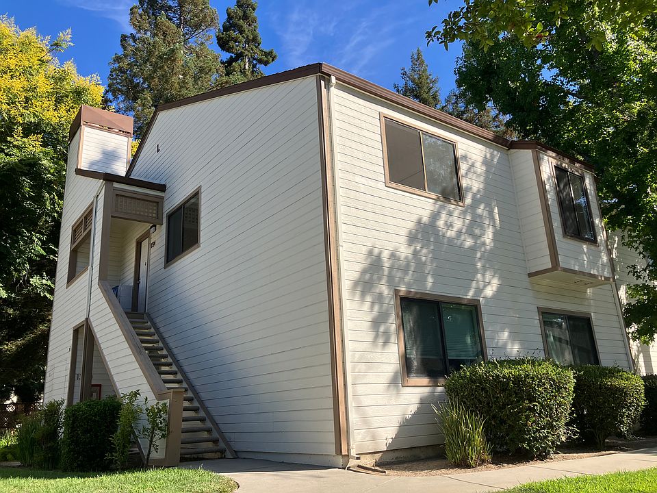 End unit exterior with staircase leading up to the unit front door