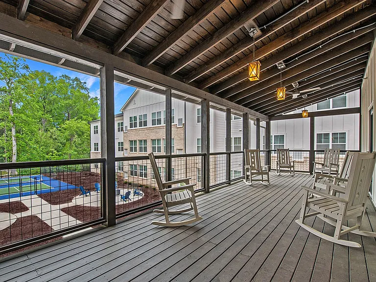 Active Adult Apartments with a covered deck with rocking chairs