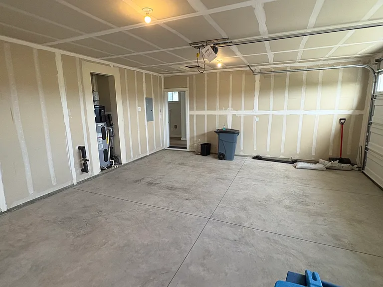 Extra wide garage. Wide enough for 2 smaller cars or an SUV and storage/home gym/workbench. Great size for home.