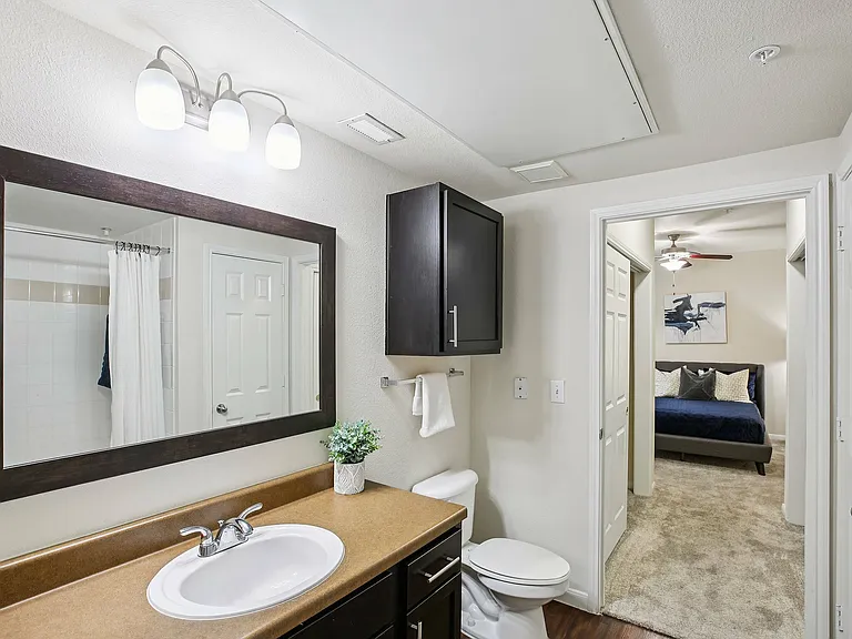 Bright bathroom with subway-tile walls and chrome accents at Providence Uptown in Houston