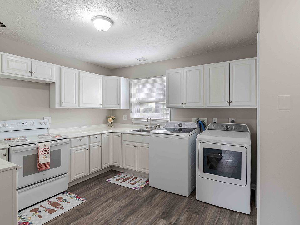 a white kitchen with white appliances and white cabinets