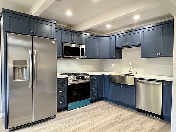 Just installed - custom stainless kitchen with top quality appliances: side-by-side refrigerator w/ water & ice, Gas range w/ convection oven, Vented microwave, Stainless farmers sink + cutting / drain board, Silent dishwasher, Custom cabinets, LED lights