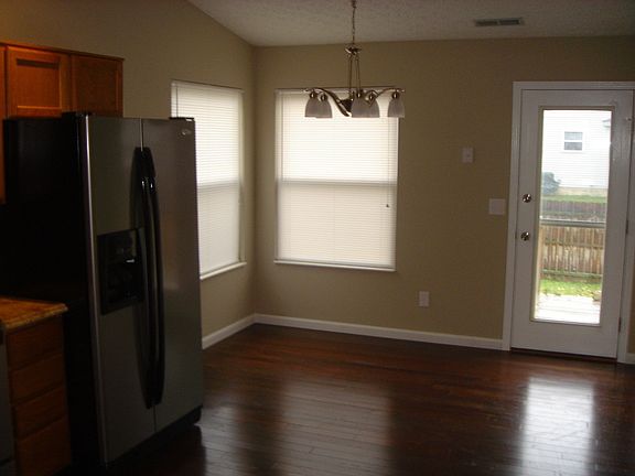 Eating area in kitchen with access to deck and fenced backyard.