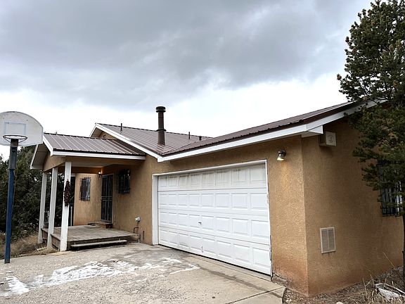 Two Car Garage with a Driveway big enough for six more cars. Basketball hoop included!