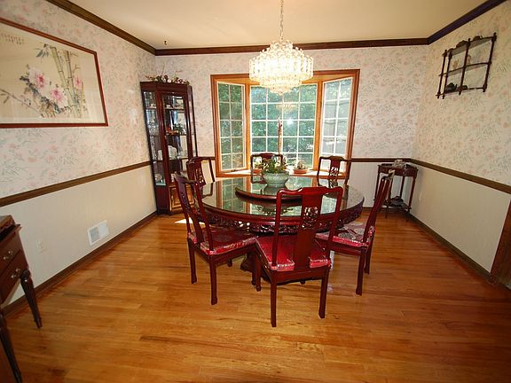 Dining Room - hardwood floor, bay window, crown molding