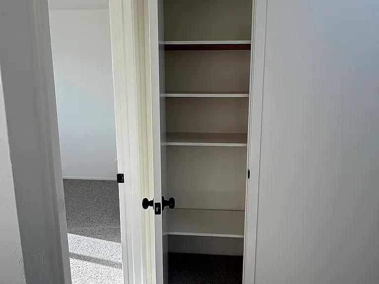 linen closet or pantry in the back hallway opposite the kitchen.
