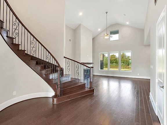 The full oak curved staircase makes for a grand entry.