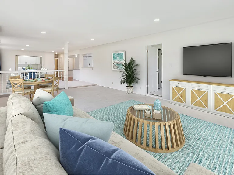 Family room with lots of space. Door to left of media console is the primary bedroom. Far end of room is the laundry room (doors opened to show, but can be closed off.)