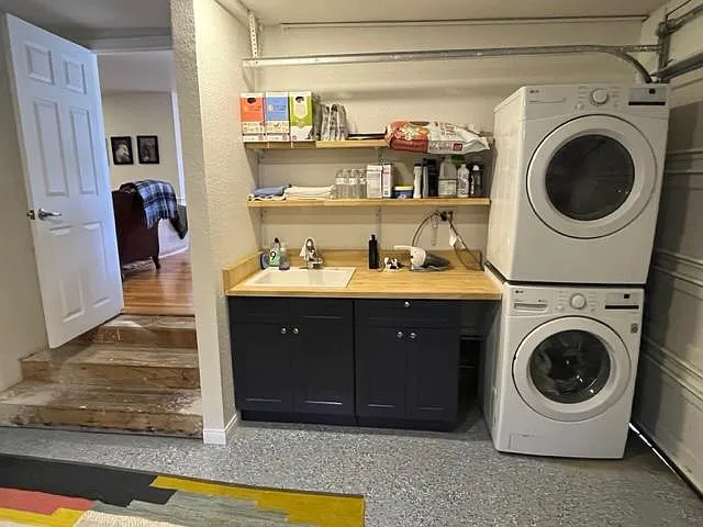 Garage with washer and dryer, new epoxy flooring.