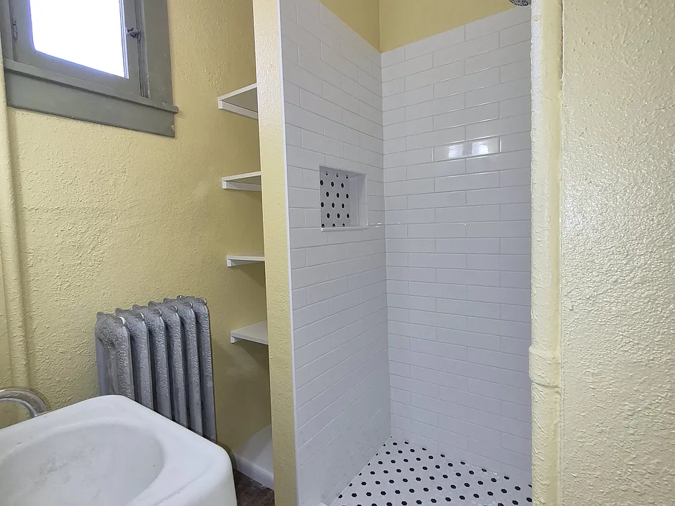 Brand new tile shower just installed! Added shelving and storage next to the shower for linens and such!!