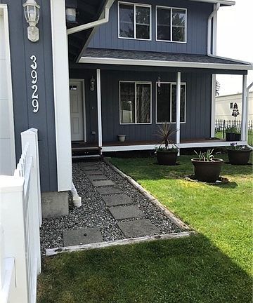 Cute front porch and a lawn easy to care for.