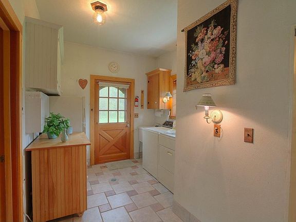 Laundry area w/laundry tub and door to back of property