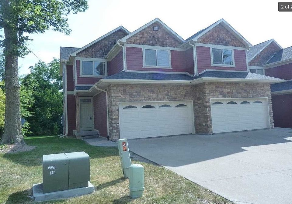 Front of house (end unit) w/ 2-car garage and driveway