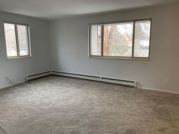 Living room has big windows.