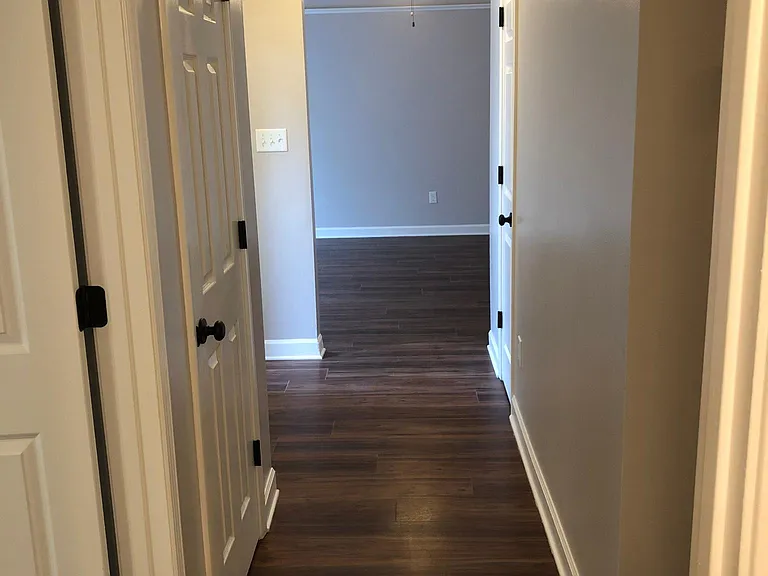 Looking from second bedroom to great room - two storage closets and front door on left
