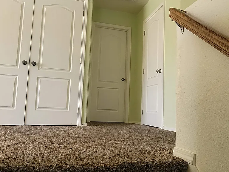 Coming up the stairs the left doors are the laundry. Middle door is master bedroom. Right door is the utility room.
