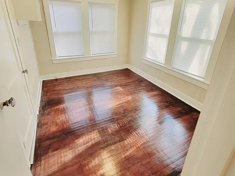 Second Bedroom with hardwood floors, adjacent to bathroom
