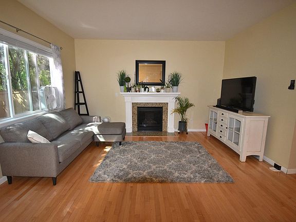 Living area with gas fireplace and hardwood floors