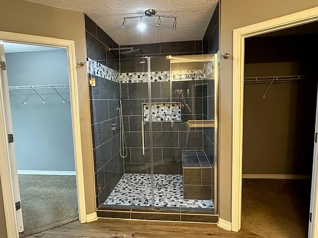 Primary shower and 2 walk-in closets