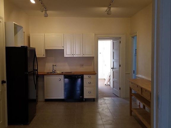 2nd half of eat in kitchen with cooking, storage and dishwasher visible