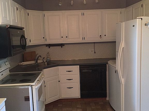 Photo of the kitchen before the laundry unit was installed. The refrigerator is now moved and built-in laundry is placed instead (see other images).