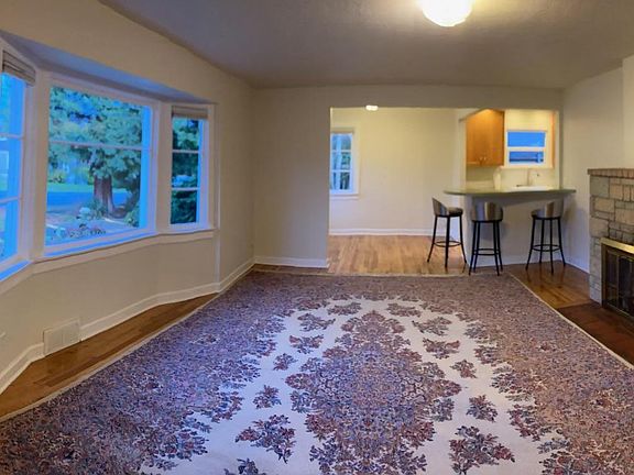 Living room wide angle. With large area rug (included) and bar stools (included). Flatscreen mount above fireplace included.