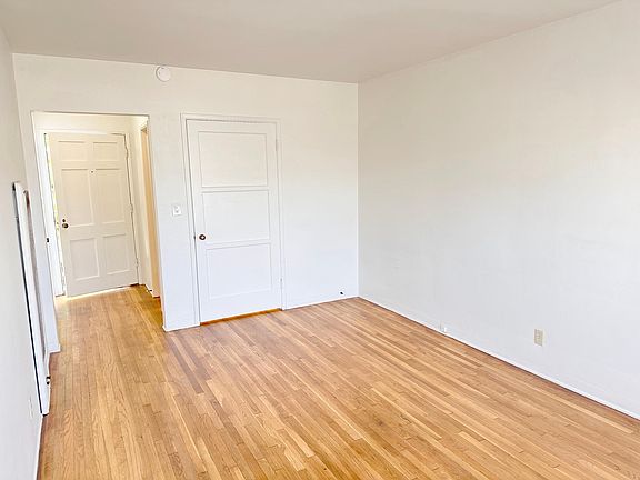 Living room view towards hallway and closet area