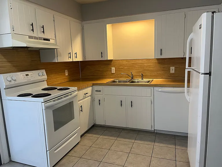 Freshly painted cabinets and new hardware.
