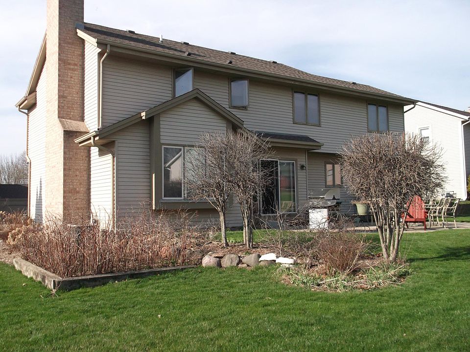 Raspberry bushes on left side of house. 