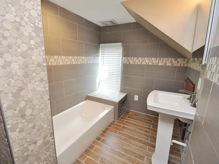 Marble, Granite, and porcelain Tile bathroom with heated floors and spa-quality fixtures and tile-work.