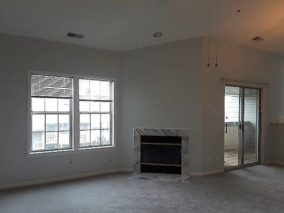 Warm and inviting living room with skylights and plenty of w