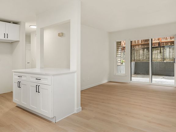 Bright kitchen is open to the living room and private patio.