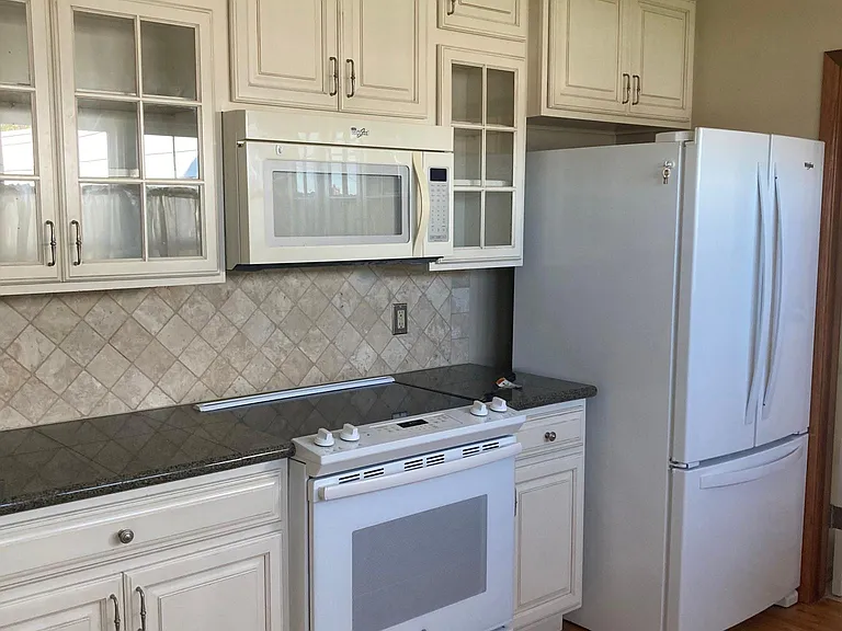 Microwave, refrigerator, and electric stove/oven.