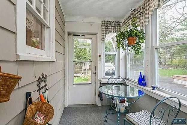 rear porch sunroom area that enters from the backyard/driveway into the kitchen area