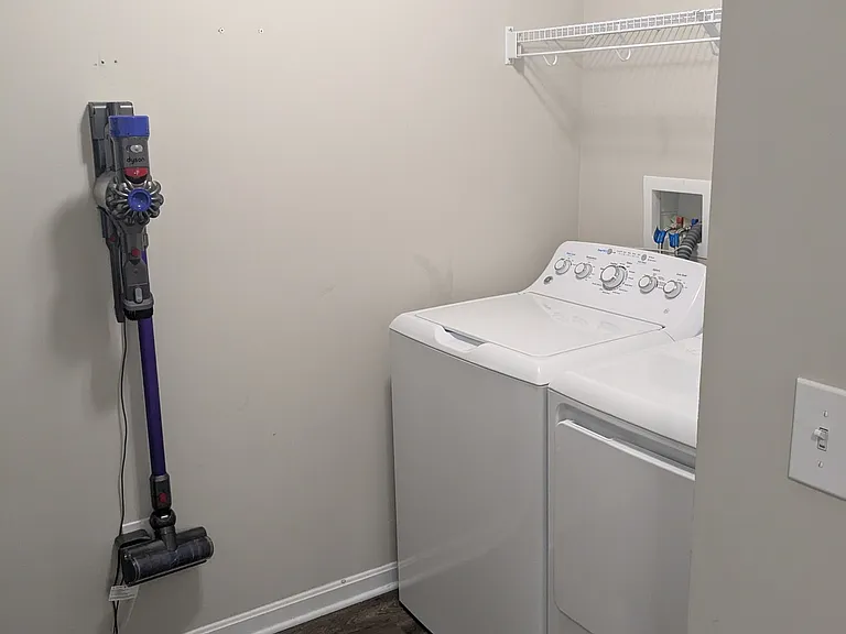 laundry room between pantry and refrigerator in kitchen.