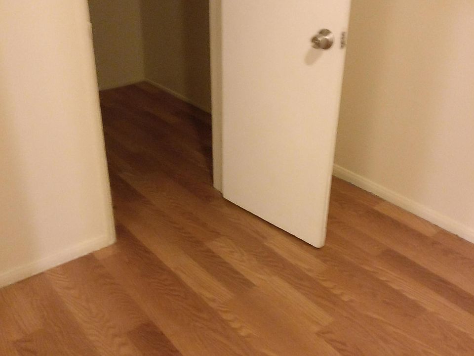 Another bedroom with laminate flooring with walk in closet
