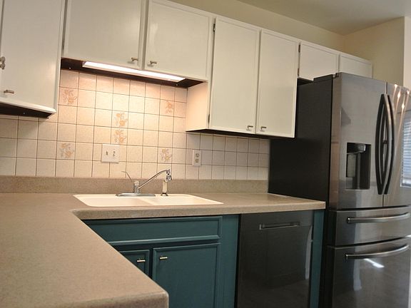 Kitchen with large new refrigerator and dishwasher