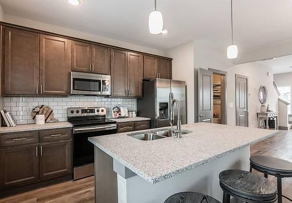 Powder room and closet to right of kitchen. Dishwasher in center island.