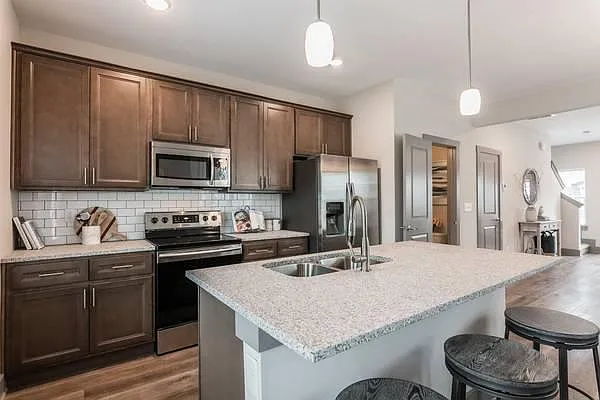 Powder room and closet to right of kitchen. Dishwasher in center island. - 632 Bristol Creek Dr