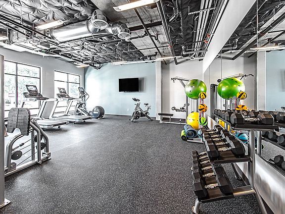 Fitness center with cardio and strength training equipment.