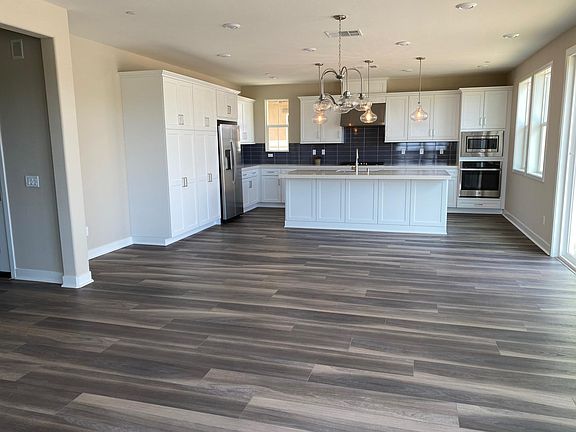 Quartz counter tops and white Shaker cabinets.