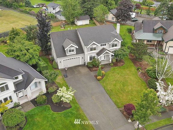 Aerial view of front yard which has a full sprinkler system.