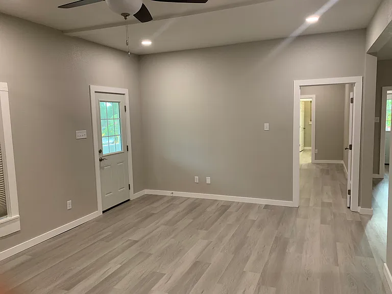 Living Room. Door out to screen porch and door into master bedroom.